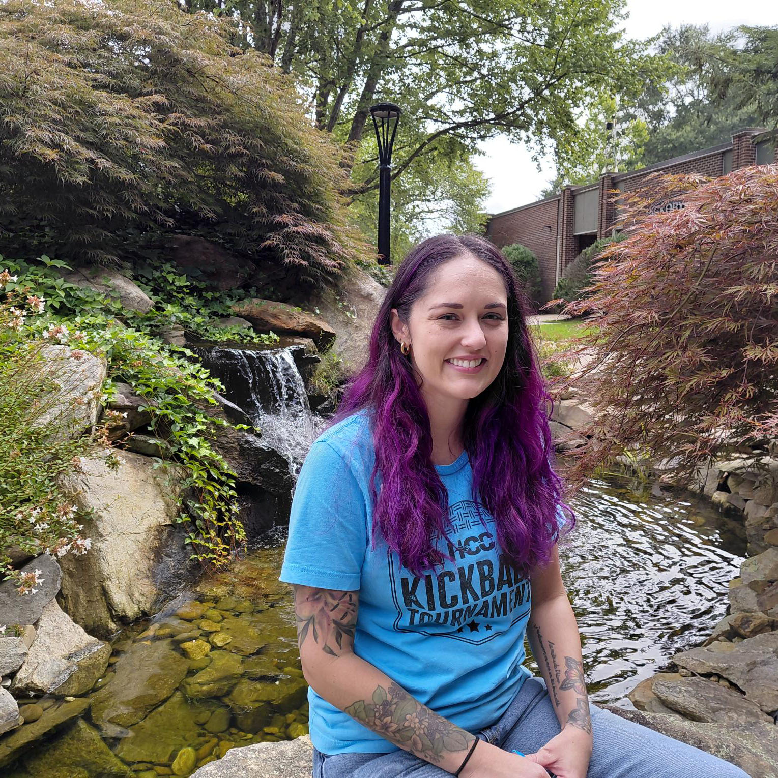 Elan Seago sitting in front of fountain